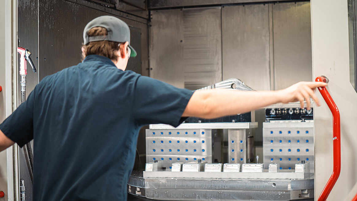 The HERMLE C 62 machine operator inspects an aerospace component at Seyer Industries.