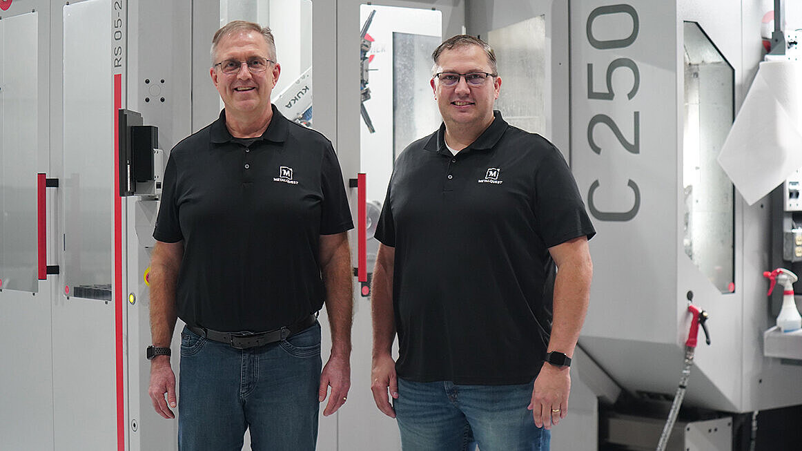 Metal Quest Unlimited President and CEO, Scott Harms, and Director of Operations Ryan Johnson in front of the C 250 with RS 05-2 automation.