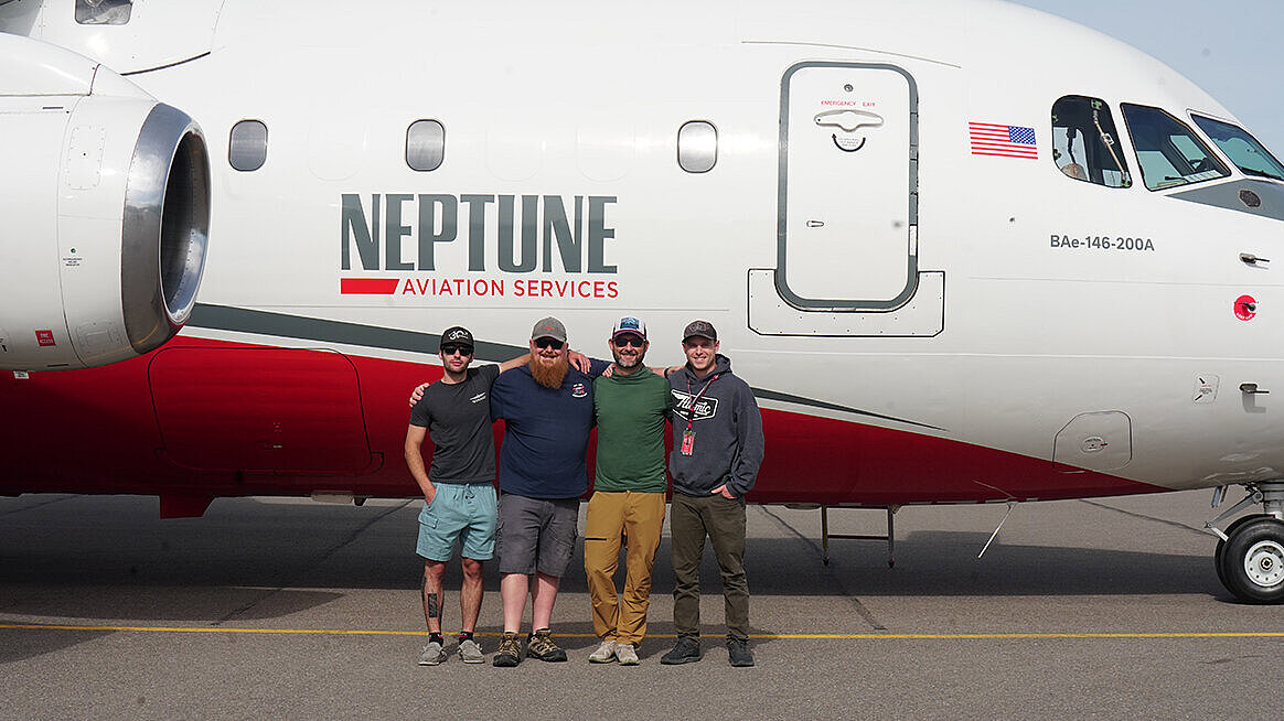 Neptune Aviation team members gather as they prepare for an aerial mission to combat wildfires throughout the United States.